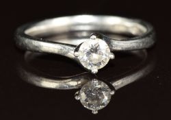 A platinum ring set with a round cut diamond of approximately 0.26ct, 3.5g, size K