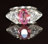 An 18k white gold ring set with a 2.5ct oval cut natural untreated Sri Lankan sapphire and two