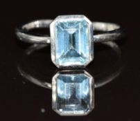 A 9ct white gold ring set with an emerald cut topaz, 2.8g, size N