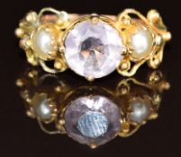 A 9ct gold ring set with a round cut amethyst and two split pearls, 2.3g, size P