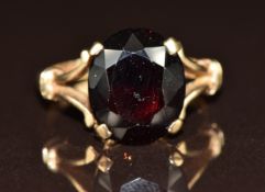 A 9ct gold ring set with an oval cut garnet, 3.5g, size L