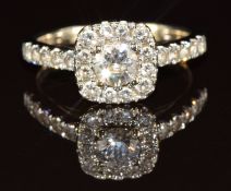 An 18ct white gold ring set with a 0.44ct round cut diamond surrounded by further diamonds and