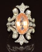 Victorian ring set with an oval cut imperial topaz of approximately 6.5ct surrounded by rose cut and