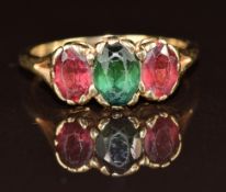 A 9ct gold ring set with an oval cut tourmaline and two oval cut garnets, 2.7g, size N