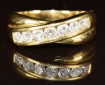 An 18ct gold ring set with seven round cut diamonds of approximately 0.08ct to 0.12ct in a cross