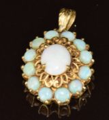 An 18ct gold pendant set with opals, 5.9g, 1.6 x 3cm