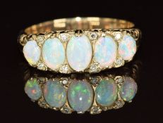 A 9ct gold ring set with five opal cabochons and diamonds, 3.8g, size O