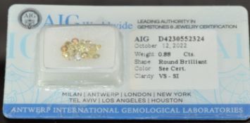 Nineteen natural light yellow to orange round brilliant cut diamonds, each measuring approximately