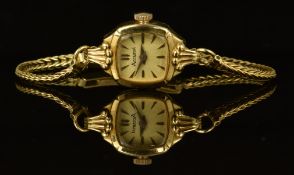 Accurist 9ct gold ladies wristwatch with gold hands and hour markers, champagne dial and signed 21