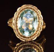 An 18ct gold ring set with a synthetic stone, 8.6g, size P