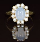 A 9ct gold ring set with a moonstone cabochon surround by pearls, 3g, size O