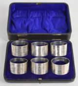 Cased set of Victorian hallmarked silver napkin rings with Aesthetic style engraved decoration of