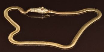 A c1920 yellow metal serpent/ snake necklace set with garnet eyes, 24.2g, 42cm