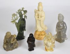 A collection of Chinese jade or similar hardstone / glass figures including Guanyin, Buddha etc.,