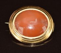 Victorian yellow metal brooch set with an agate cabochon / intaglio seal carved to the underside