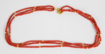 A three strand coral necklace with 18k gold beads and 18k gold clasp, 29.2g, 44cm