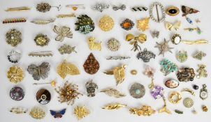 A collection of brooches including silver filigree, Miracle, enamel and marcasite, Swarovski, silver