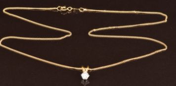 An 18ct gold pendant set with a round cut diamond of approximately 0.33ct, on 18ct gold chain, in