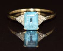 A 9ct gold ring set with a blue topaz and diamonds, 1.9g, size S/T