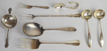 American silver comprising large serving spoon, serving fork, pickle fork or similar, shorter pickle