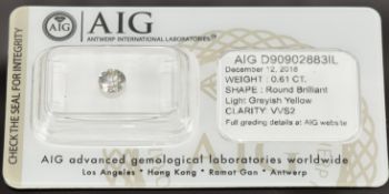 A loose 0.61ct round brilliant cut light greyish yellow diamond, with certificate