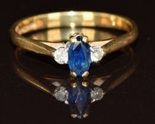 An 18ct gold ring set with a marquise cut sapphire and two diamonds, 2.2g, size L