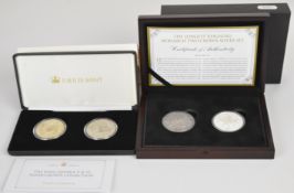 Two cased pairs of silver crowns comprising Longest Reigning Monarch 1889 Victorian and 1977