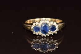 A 9ct gold ring set with three sapphires surrounded by diamonds, 3.8g, size T