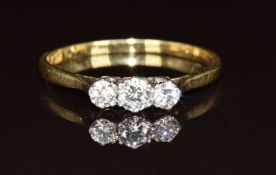 An 18ct gold ring set with three diamonds, 1.5g, size N