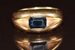 An 18ct ring set with an emerald cut sapphire, 11.6g, size Q