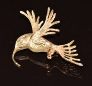 A 9ct gold brooch in the form of a hummingbird set with an emerald eye, 6.3g, 4cm