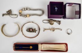 A collection of jewellery including silver bangle, silver brooch in the form of a jockey cap and