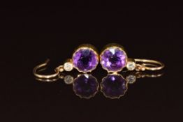 Edwardian pair of yellow metal earrings each set with a round cut amethyst and diamond (test as