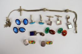 Four pairs of silver cufflinks including two pairs set with enamel, one set with mother of pearl and