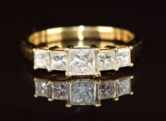 An 18k gold ring set with five princess cut diamonds, the centre diamond approximately 0.45ct, 3g,