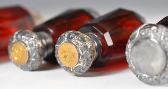 Nine glass double ended scent / perfume bottles, most cut and with hallmarked silver mounts, tallest