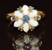 A 9ct gold ring set with opals and sapphires in a floral cluster, 3.2g, size Q