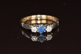 A 9ct gold ring set with a round cut sapphire and two diamonds in a platinum setting, 2.4g, size L