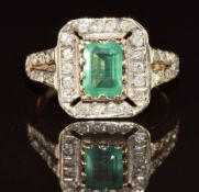 A 9ct gold ring set with an emerald cut emerald of approximately 1ct surrounded by diamonds, 3.2g,