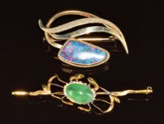 A 10k gold brooch set with a black opal doublet (5.1g, 4cm) and a yellow metal brooch in the form of