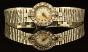 Art Deco style platinum ladies wristwatch with diamond set bezel, Arabic numerals, silver dial and