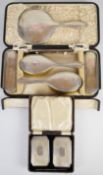Hallmarked silver dressing table comprising hand mirror, two pairs of brushes and a comb, Birmingham
