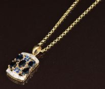 A 9ct gold pendant set with five oval cut sapphires, eight round cut sapphires and diamonds, on