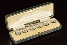 A set of six 15ct gold studs/ buttons set with mother of pearl, enamel and old cut diamonds, in