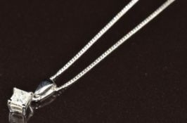 An 18k white gold pendant set with a princess cut diamond of approximately 0.25ct, on 18k white gold