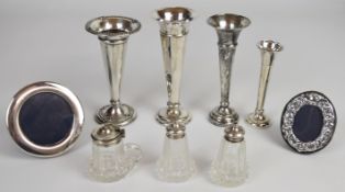 Hallmarked silver items comprising four trumpet vases, two photograph frames and a cut glass