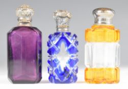 Three 19th / 20thC cut glass scent bottles with hallmarked silver / white metal mounts, includes