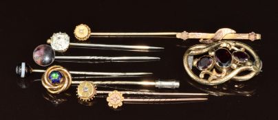 Seven Victorian stick pins including paste, banded agate, 9ct gold set with a diamond, 9ct gold