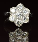 An 18ct white gold ring set with seven diamonds of approximately 0.4ct each in a cluster setting,