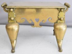 Brass twin handled footman with fretwork apron, W54 x D28 x H30cm